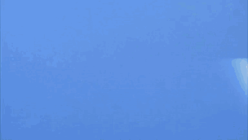 Two Fighter Jets Are Flying In A Blue Sky And One Of Them Has The Letter K On It GIF