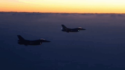 Two Fighter Jets Flying At Sunset GIF