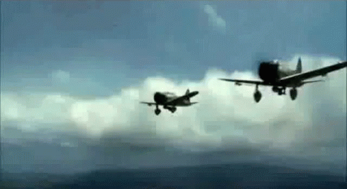 Two Fighter Planes Are Flying In The Sky . GIF