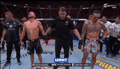 Two Fighters and Referee in Boxing Ring