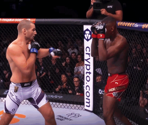 Two Fighters in Cage with Crypto.com Sign
