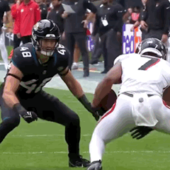 Two Football Players Are Playing A Game On A Field And One Has The Number 7 On His Jersey GIF