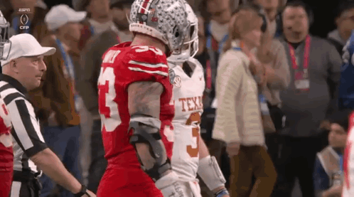 two football players are standing next to each other and one has the number 5 on his jersey
