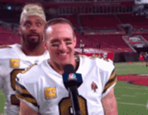 Two Football Players Are Standing On A Field And One Of Them Is Wearing A Number 9 Jersey GIF