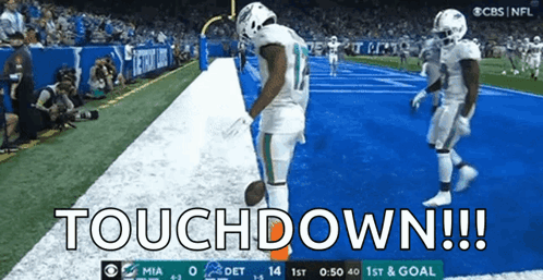 Two Football Players Celebrate A Touchdown During A Game Between The Miami Dolphins And Detroit Lions GIF