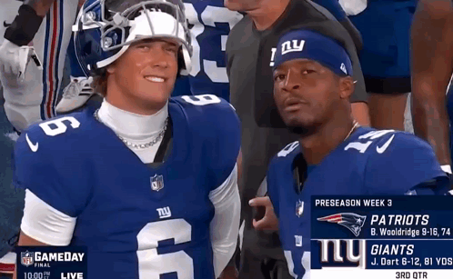 Two Football Players For The New York Giants Are Posing For A Photo GIF