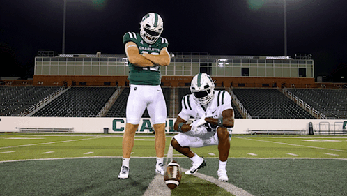 two football players from the charlotte team are posing for a picture