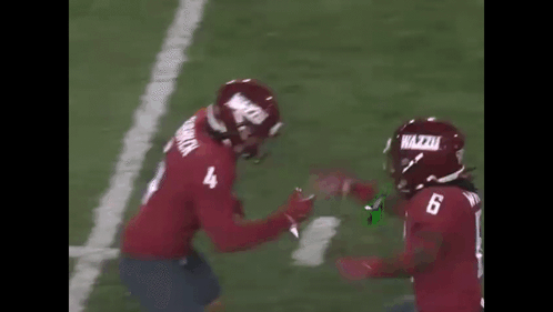 Two Football Players Hugging Number 4 Jersey