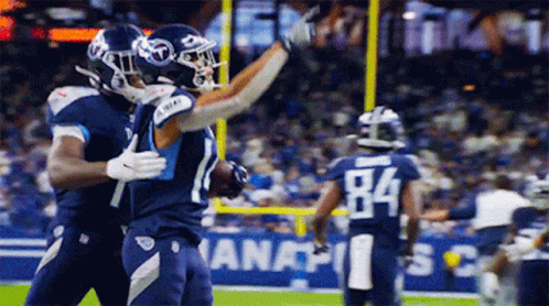 Two Football Players Hugging Number 84 GIF
