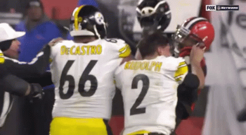 Two Football Players Hugging, One with Number 35 Jersey