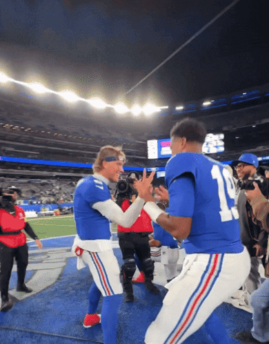 two football players in blue uniforms with the number 11 on the back