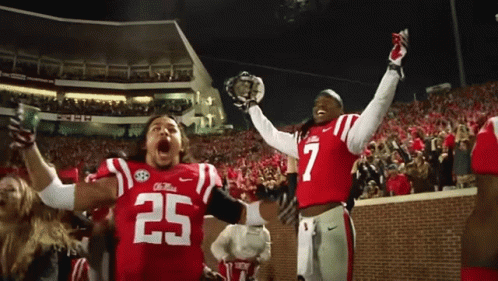 Two Football Players in Red Uniforms Number 25