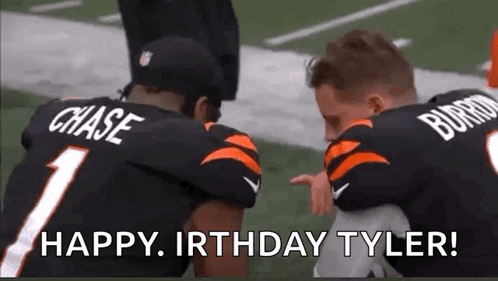 Two Football Players Kneeling Holding Child