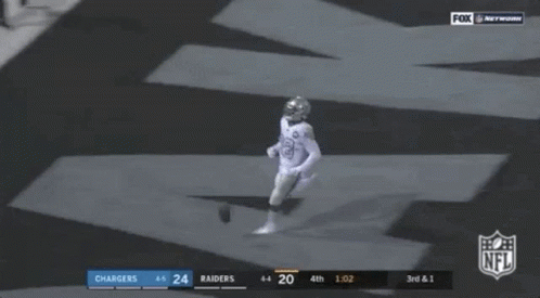 Two Football Players Laying on Ground NFL Touchdown