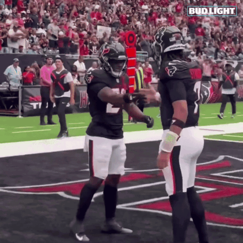Two Football Players On A Field With A Bud Light Logo On The Bottom GIF