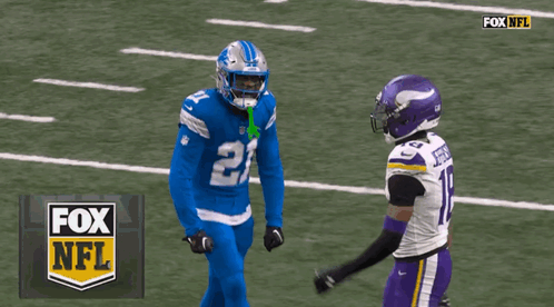 Two Football Players On A Field With The Fox Nfl Logo In The Background GIF
