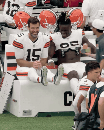 Two Football Players On Bench Number 15 GIF