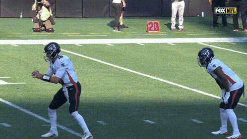 Two Football Players on Field With Fox NFL Logo