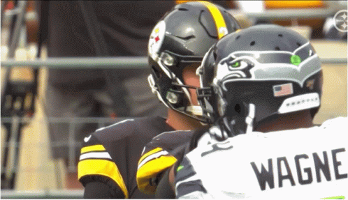 Two Football Players One In Wagner Jersey Talking GIF