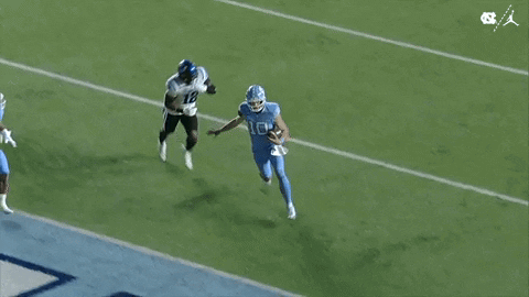 Two Football Players Running On Field GIF