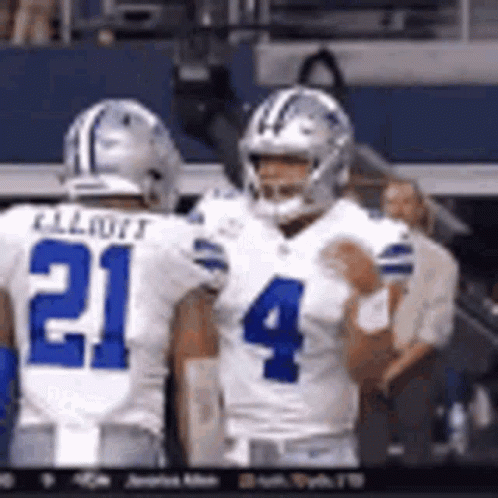 Two Football Players Standing on Field