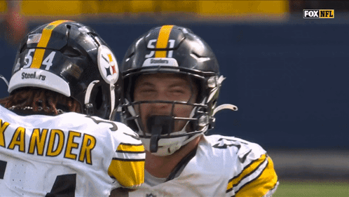 Two Football Players With Kander Jersey