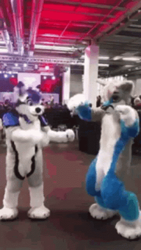 Two Furry Costumes Standing Next to Each Other