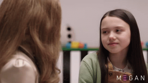 Two Girls Are Looking At Each Other With The Name Megan On The Bottom Right GIF