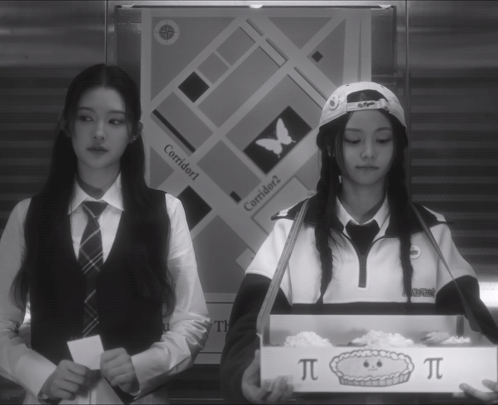 Two Girls Are Standing In Front Of A Sign That Says Corridor 1 GIF