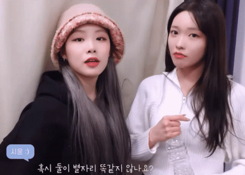 Two Girls Are Standing Next To Each Other And One Has A Speech Bubble That Says 시운 :) GIF