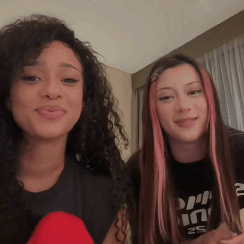 Two Girls Are Standing Next To Each Other With One Wearing A Shirt That Says ' S2 ' On It GIF