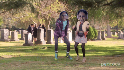 Two Girls Dancing in Cemetery with Peacock