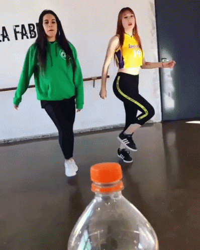 Two Girls Dancing in Front of Lafab Sign