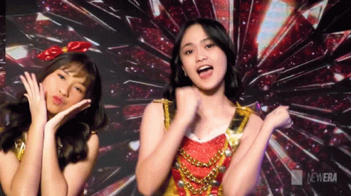 Two Girls Dancing in Front of New Era Logo