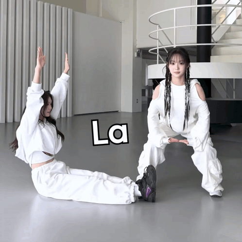 Two Girls Exercising In Room With La On Floor GIF