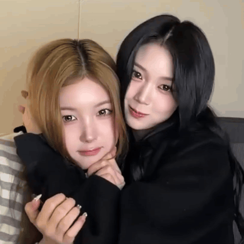 Two Girls Hugging One in Black Shirt