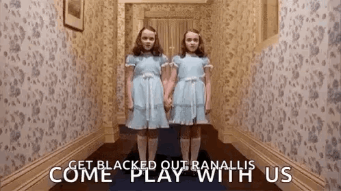 Two Girls in Blue Dresses in Hallway