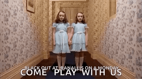 Two Girls in Blue Dresses in Hallway