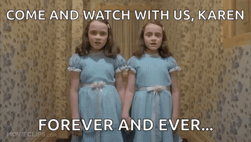 Two Girls in Blue Dresses Watching Together
