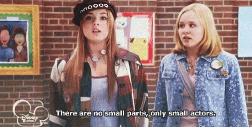 Two Girls in Front of Brick Wall Saying No Small Parts