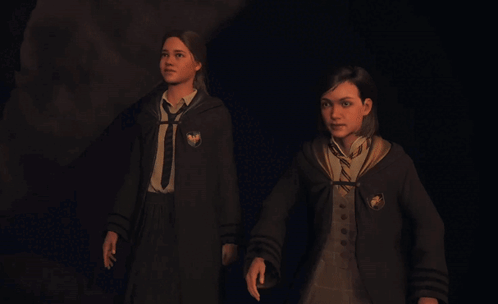 Two Girls in Harry Potter Uniforms Walking in Dark Room