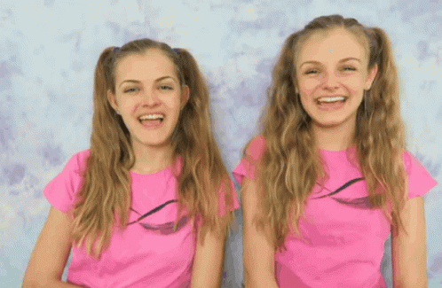 Two Girls in Pink Shirts Smiling