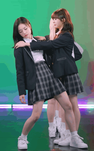 Two Girls In School Uniforms Are Posing For A Photo GIF