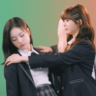 Two Girls In School Uniforms Are Standing Next To Each Other And One Is Putting Her Hand On The Other 'S Shoulder GIF