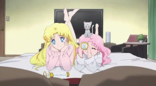 Two Girls Lying on Bed With Cat