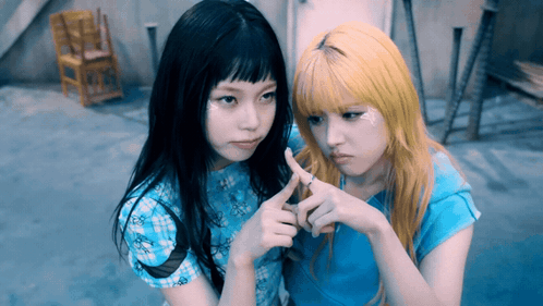 Two Girls Making Heart Shape, One Ring