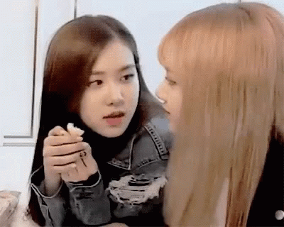 Two Girls One Holding Key Looking at Each Other