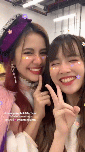 Two Girls Posing, One in Flower Hat