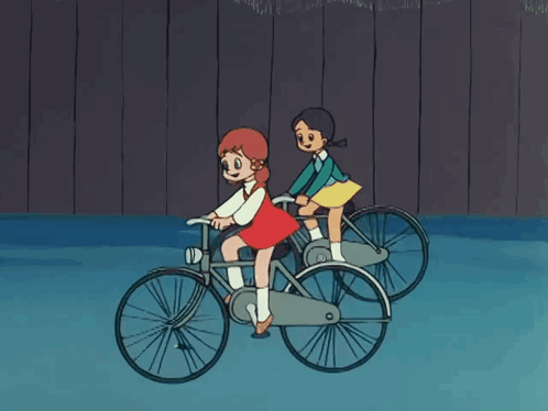 Two Girls Riding Bicycles