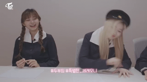 Two Girls Sitting at Table With Twice